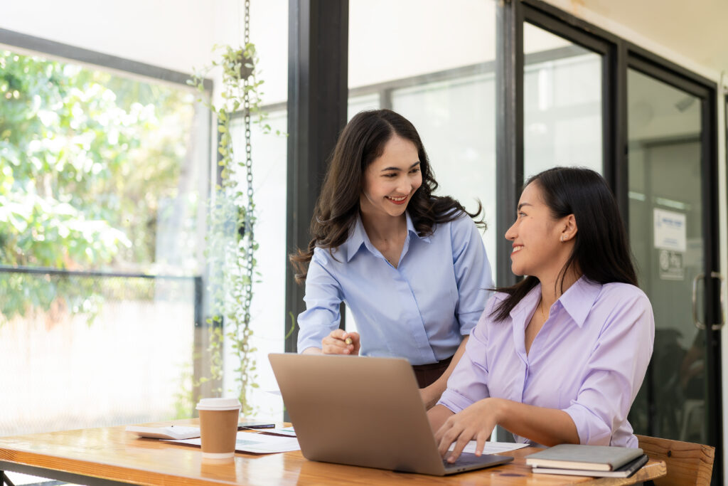 Two female Asian accountants discuss financial management planning. Analysis of new startup project ideas